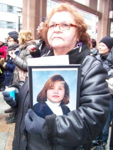Mother holding photo of daughter
